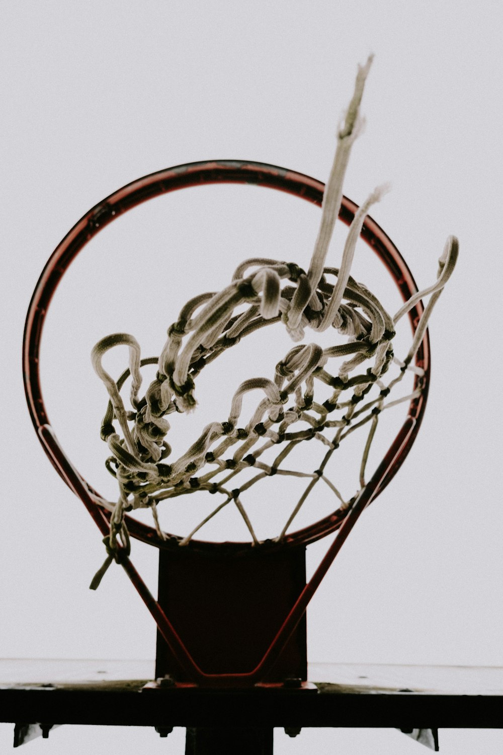 a close up of a basketball hoop with a basketball in it