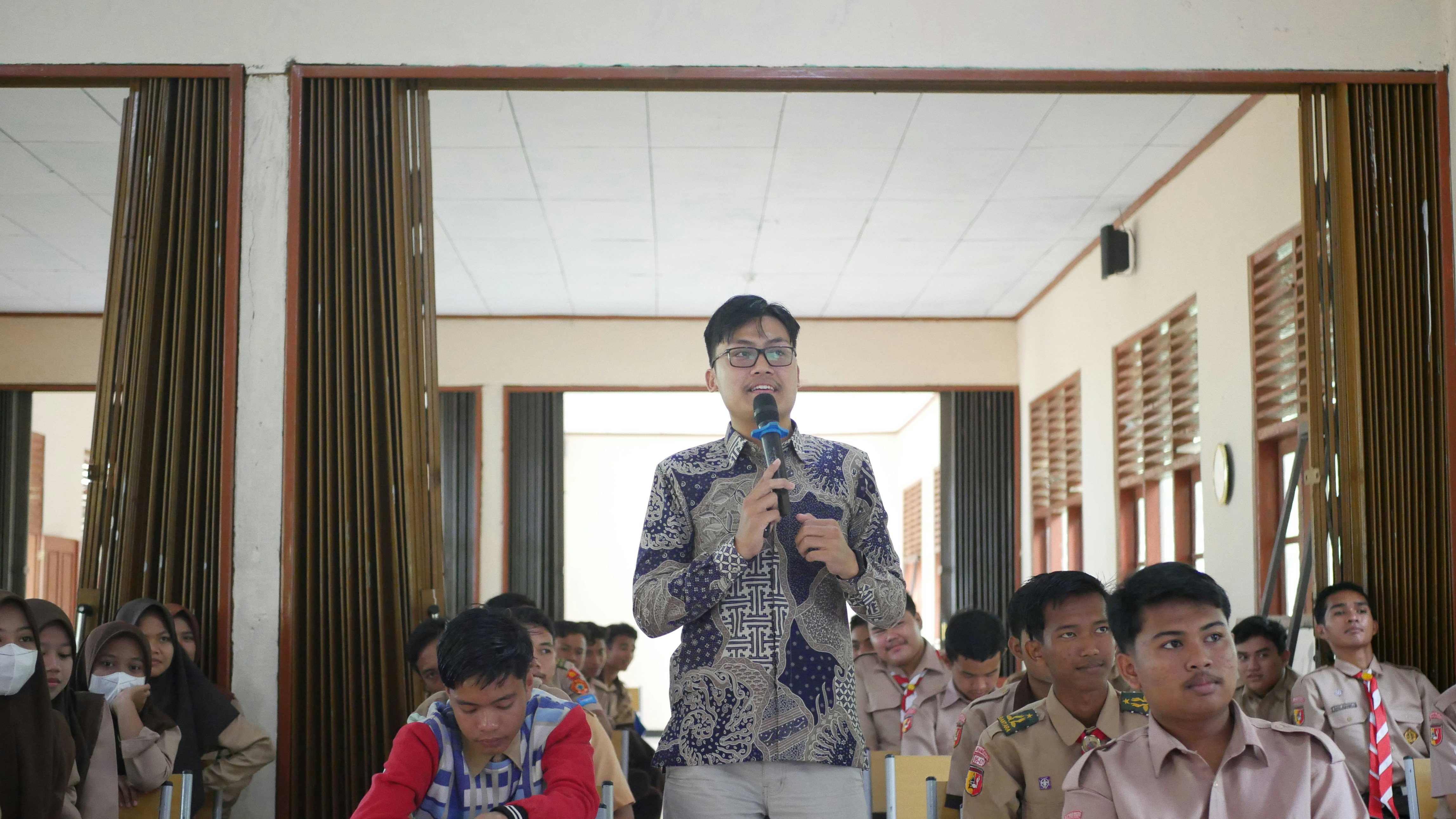 Man speaking into microphone presenting project