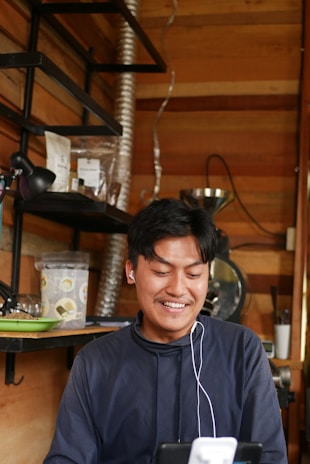 Close-up of a customer smiling while using the electronic chanting machine in a cozy room.