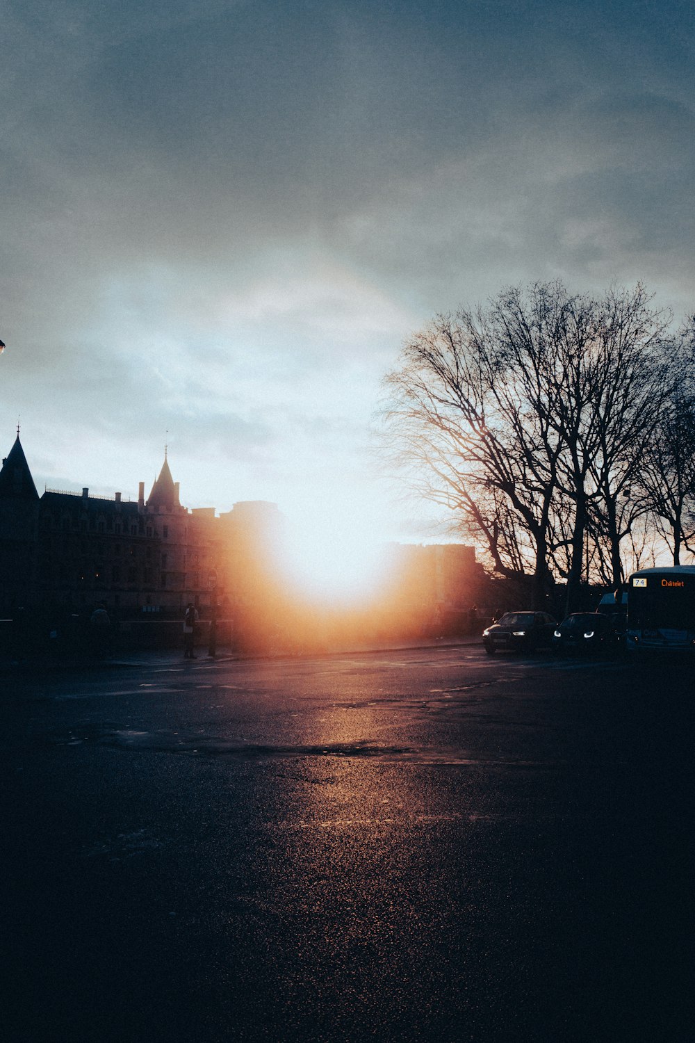 the sun is setting over a city street