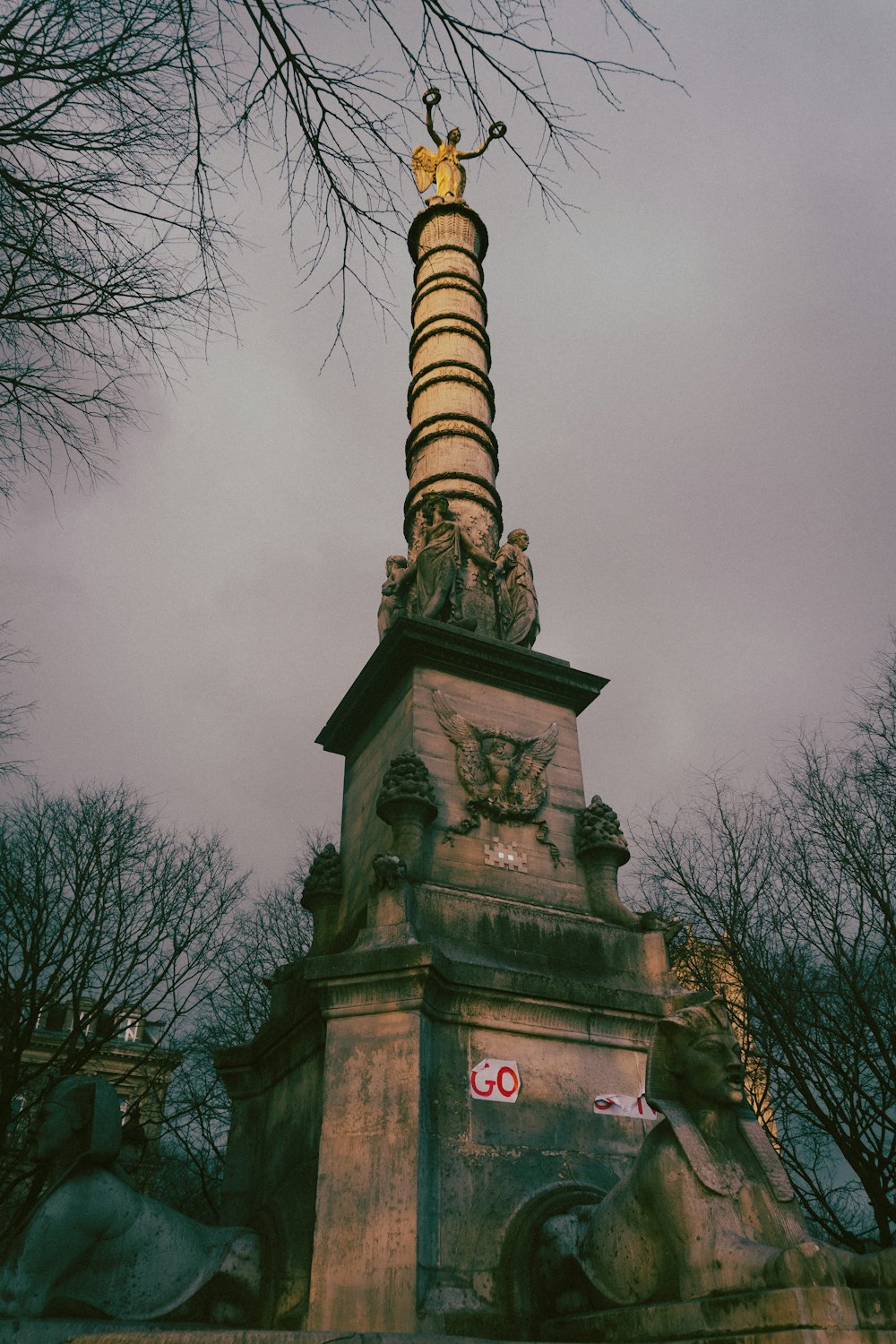 a tall tower with a statue on top of it