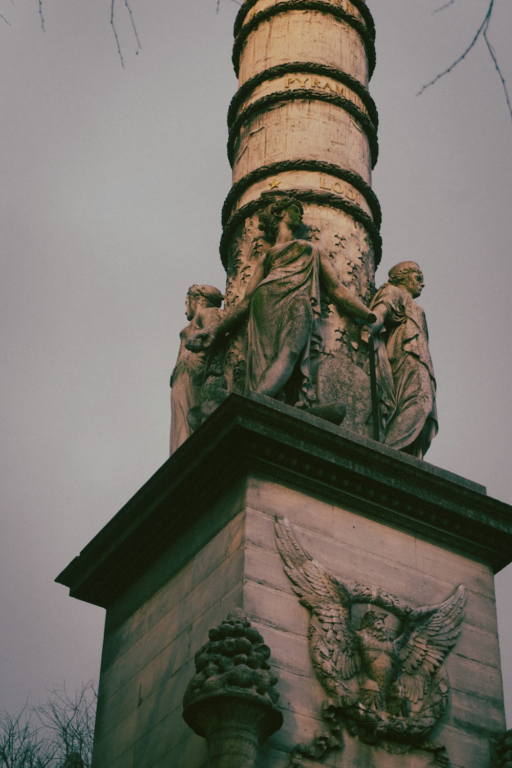 a statue on top of a tower with a sky background