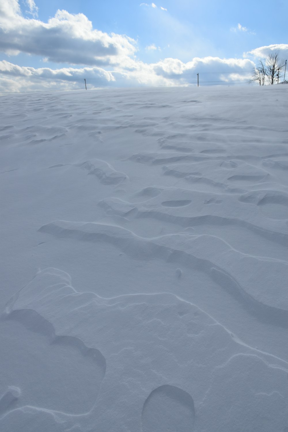 a person riding skis on top of a snow covered slope