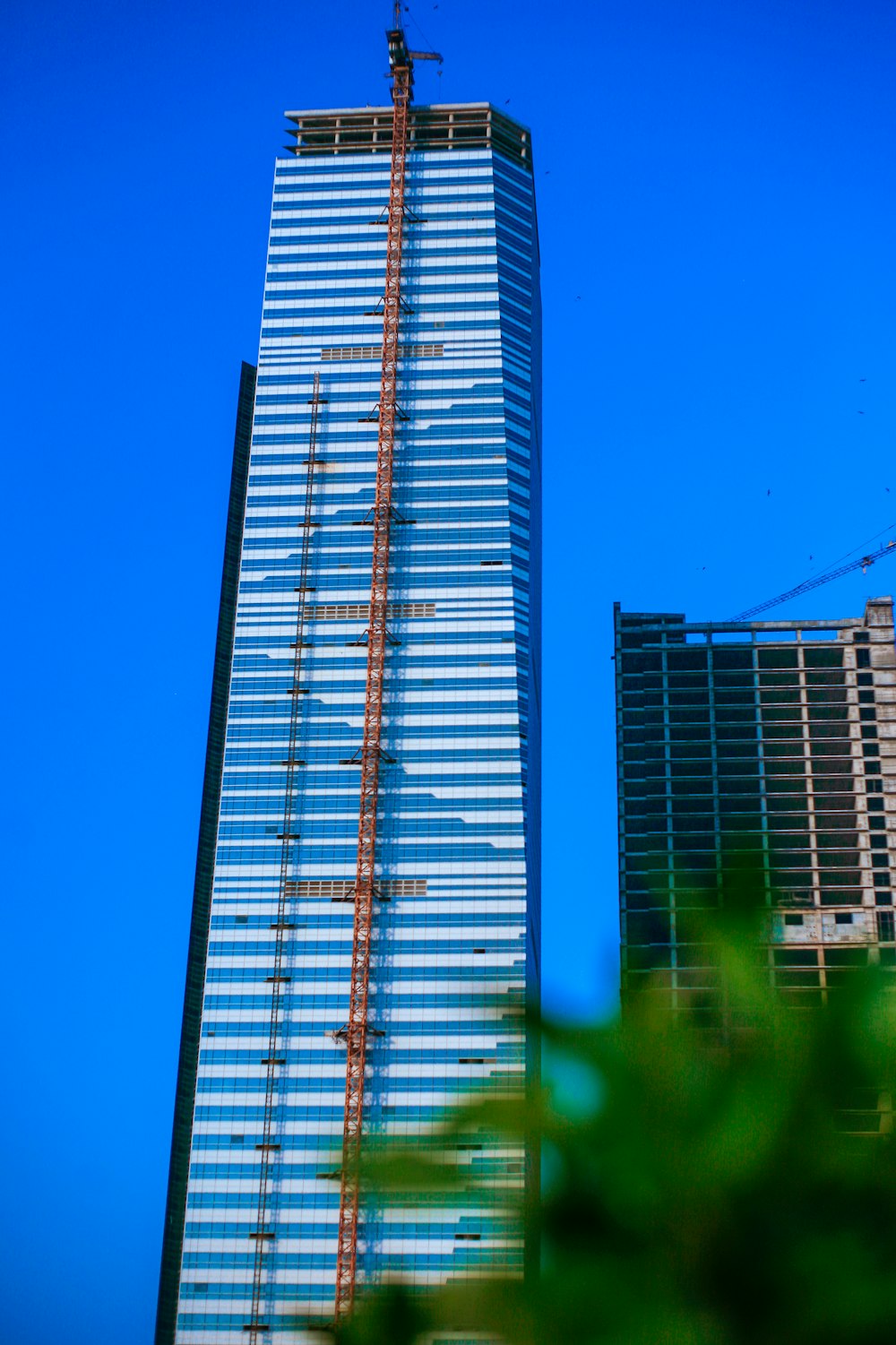 a tall building with a crane on top of it