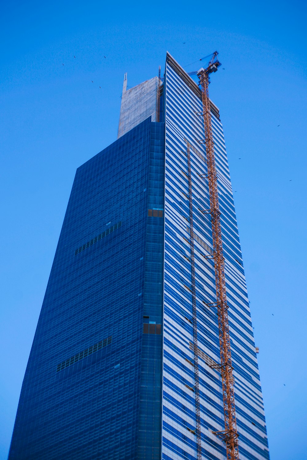 a tall building with a crane on top of it