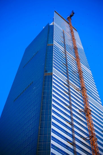 a tall building with a crane on top of it