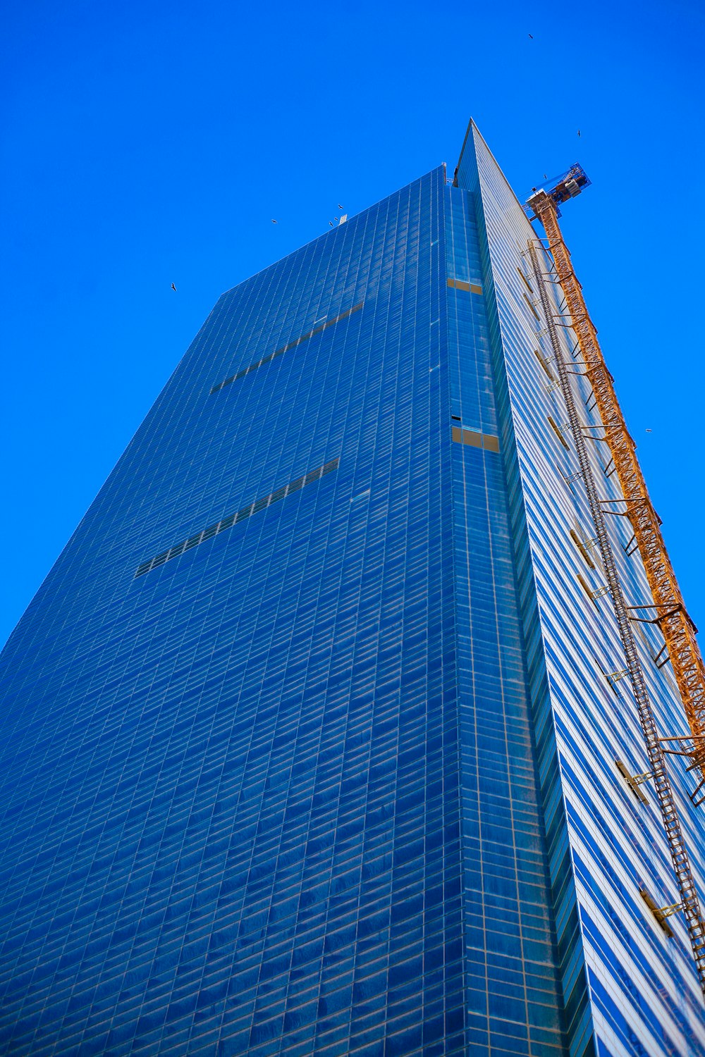 a tall building with a crane on top of it