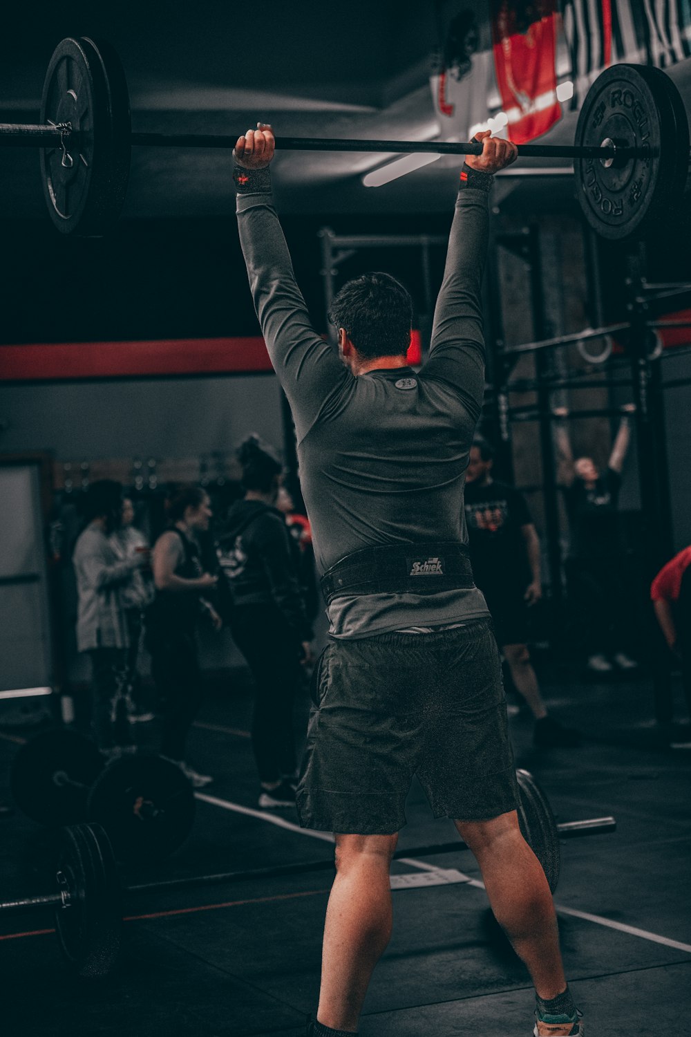 a man lifting a barbell in a gym