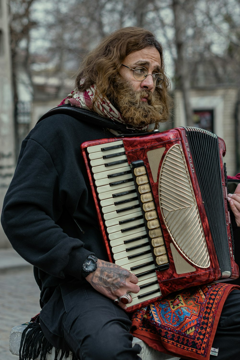 a man sitting on a bench holding an accordion