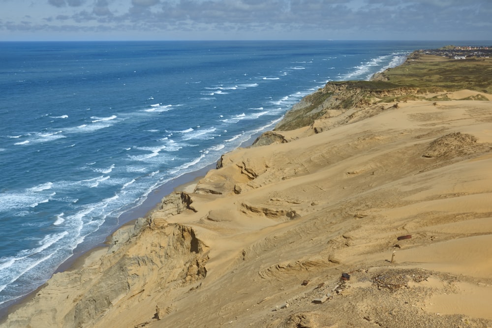 a view of the ocean from the top of a hill