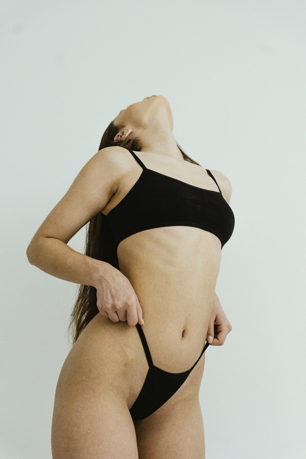 a woman in a black bikini posing for a picture