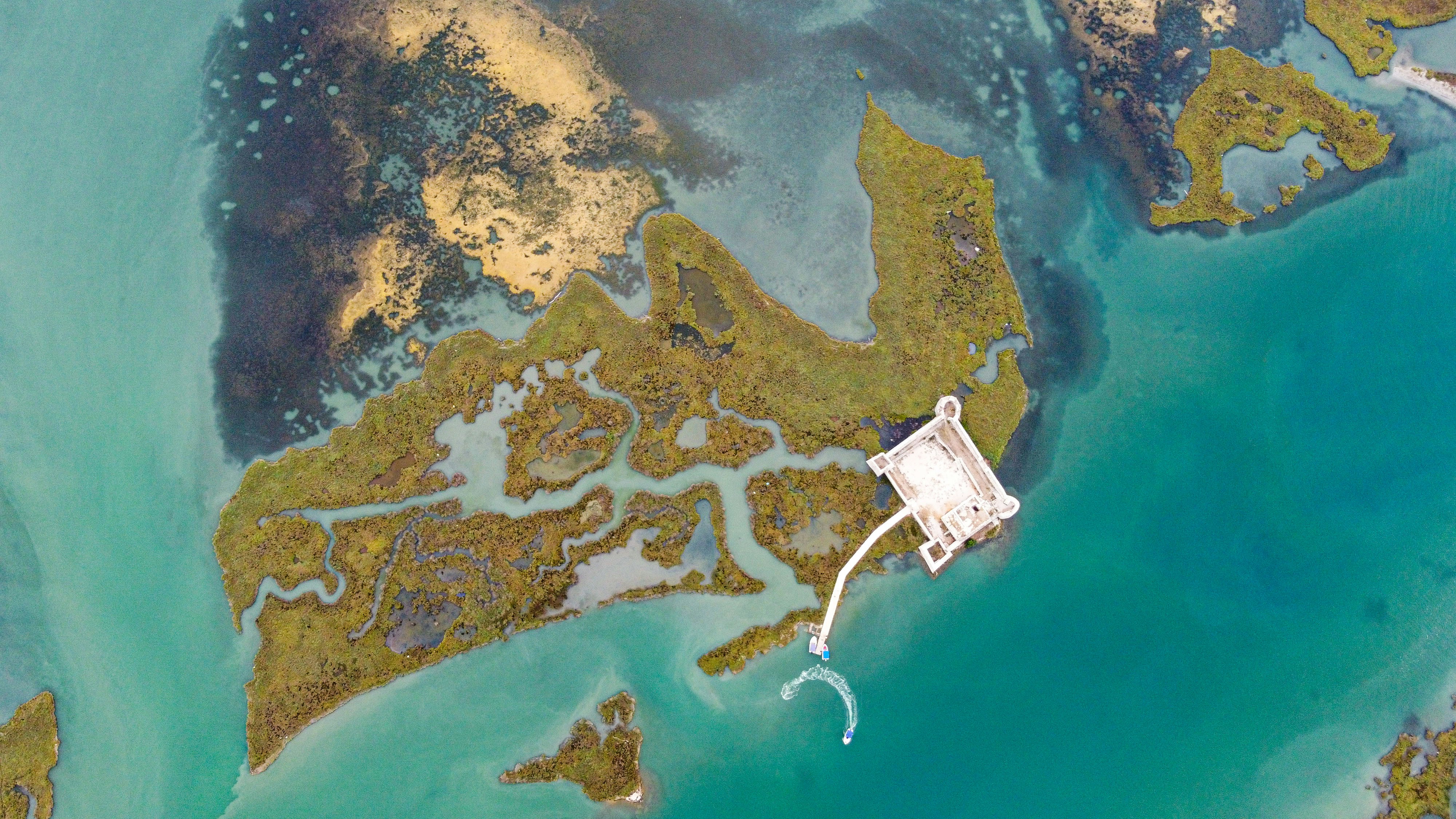 an aerial view of a body of water and land, 