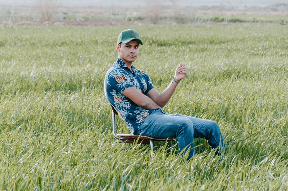 a man sitting in a chair in a field