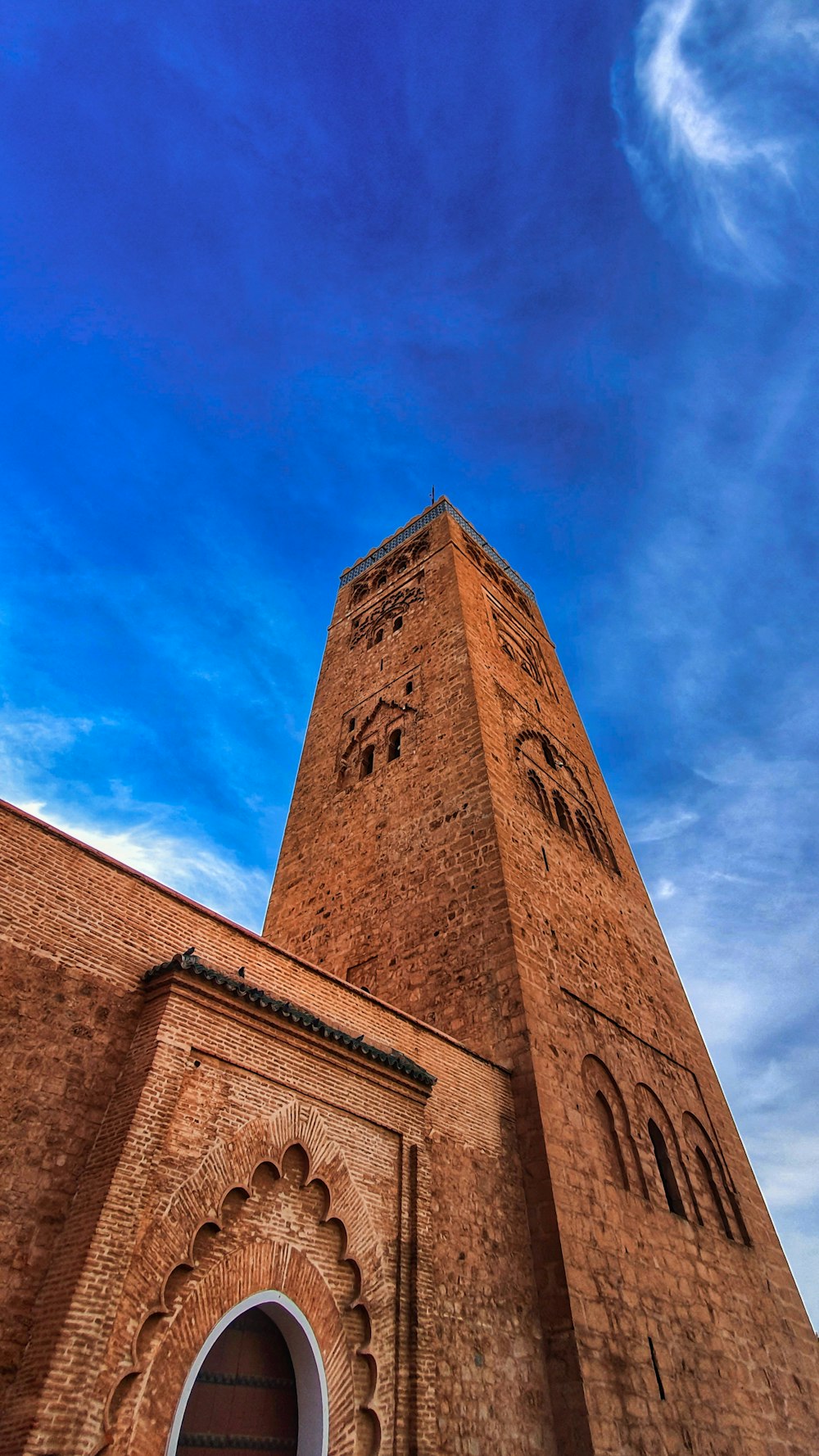 a tall brick building with a clock on it's side