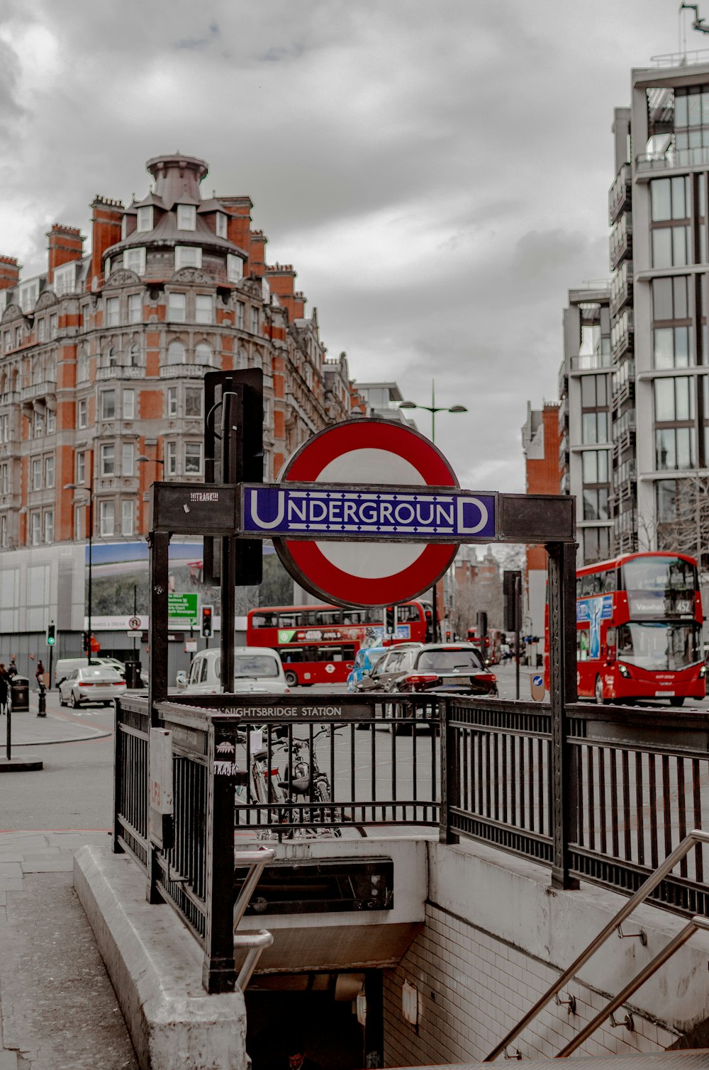 a red and white sign and some buildings and cars