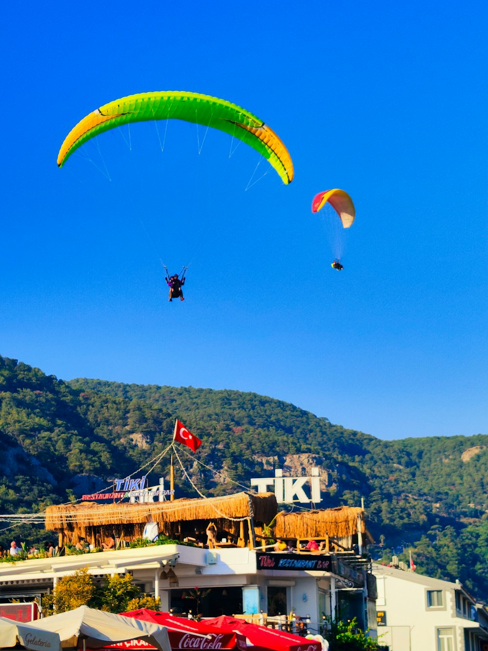 a group of people flying kites over a city