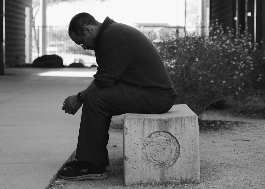 Photo of  man sitting quietly on a bench. CBT for Grief with Cognitions Counseling in Fort Mill,