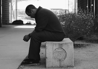 Photo of  man sitting quietly on a bench. CBT for Grief with Cognitions Counseling in Fort Mill,