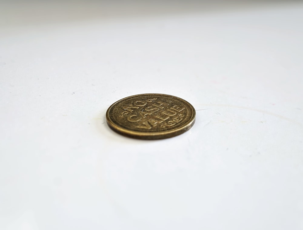 a close up of a coin on a white surface