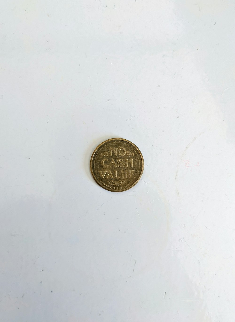 a coin sitting on top of a white surface