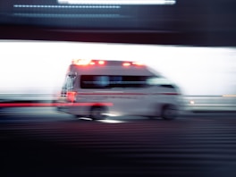 an ambulance is driving down the street with its lights on