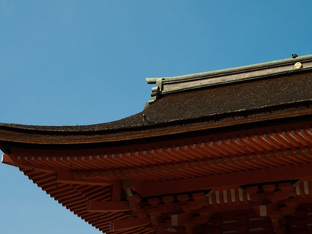 a bird is perched on the roof of a building