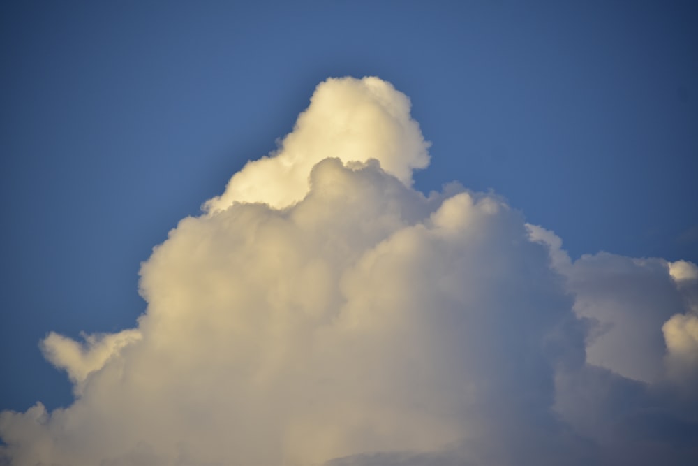 a large white cloud in a blue sky