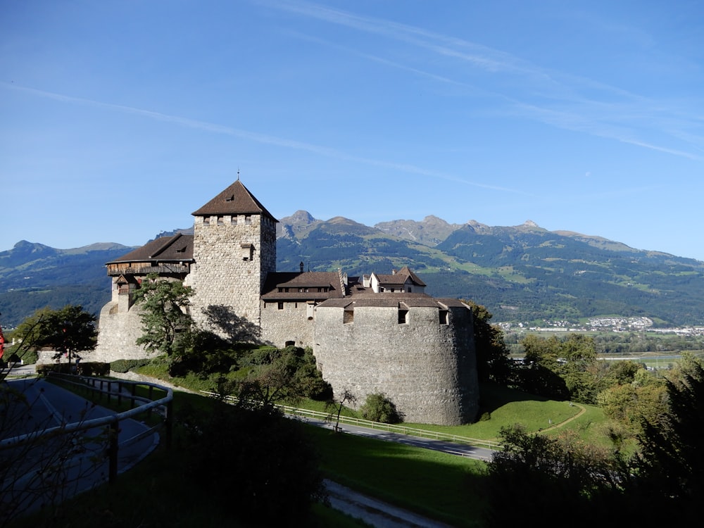 an old castle with a mountain in the background