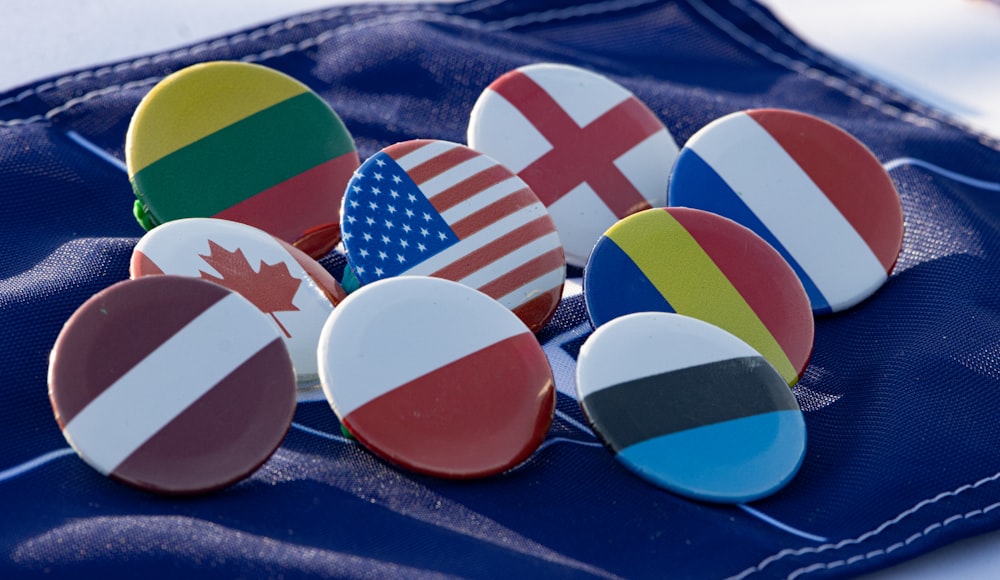 a bunch of buttons with flags on them