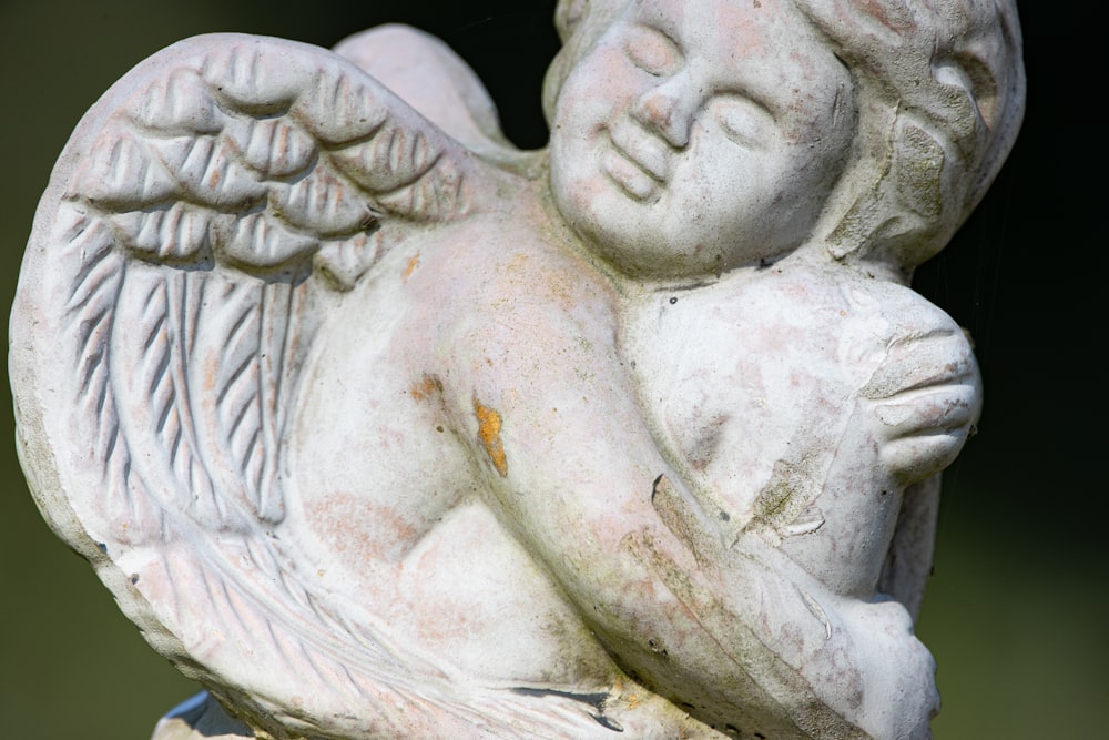 a statue of an angel holding a baby