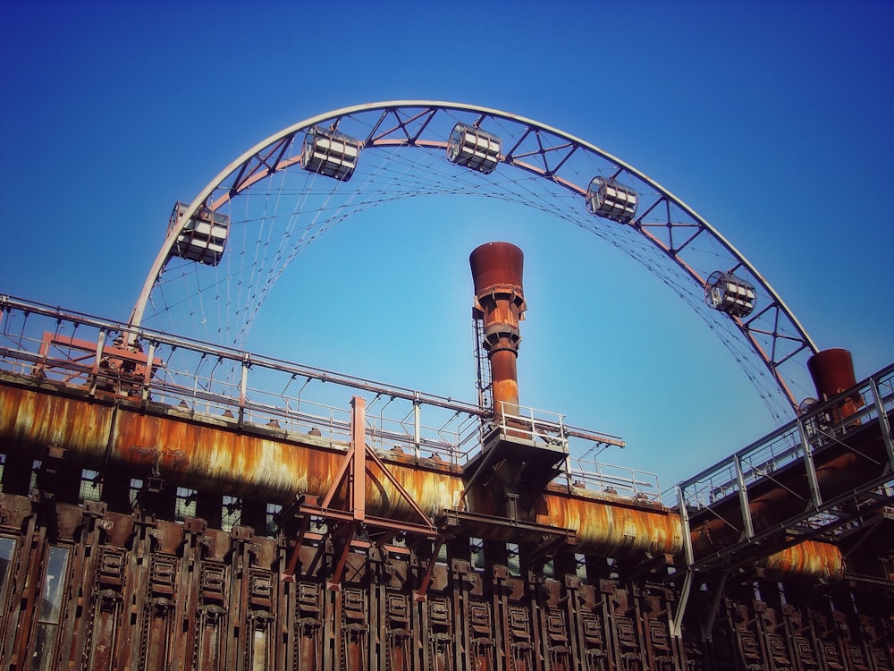 a large metal structure with a ferris wheel on top of it