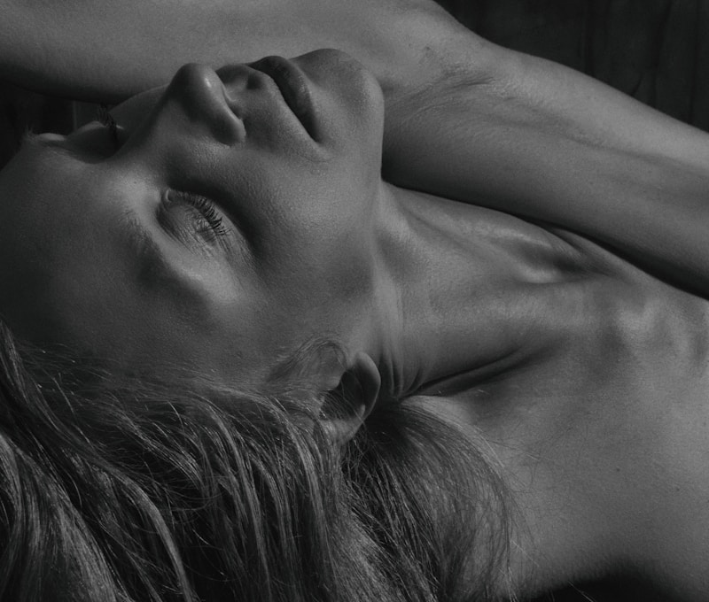 a woman laying on top of a wooden floor