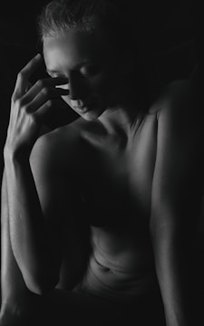 Still frame from a black and white film showing a contemplative figure.