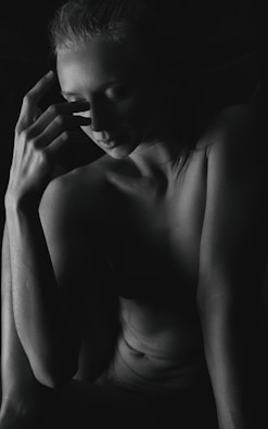 Jax Rowe in a contemplative pose against a high-contrast black and white backdrop.