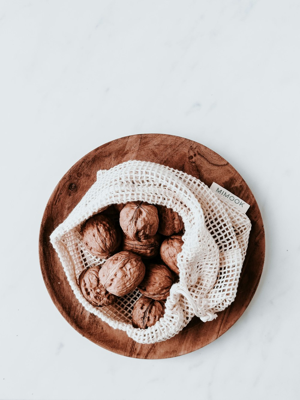 a wooden bowl filled with cookies on top of a table