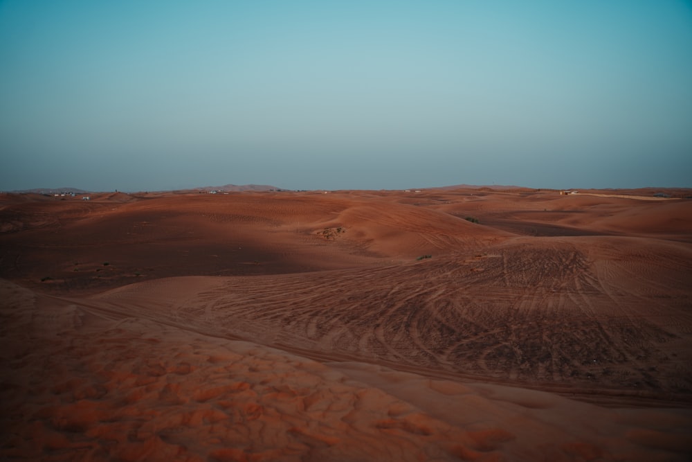 a desert landscape with a blue sky in the background