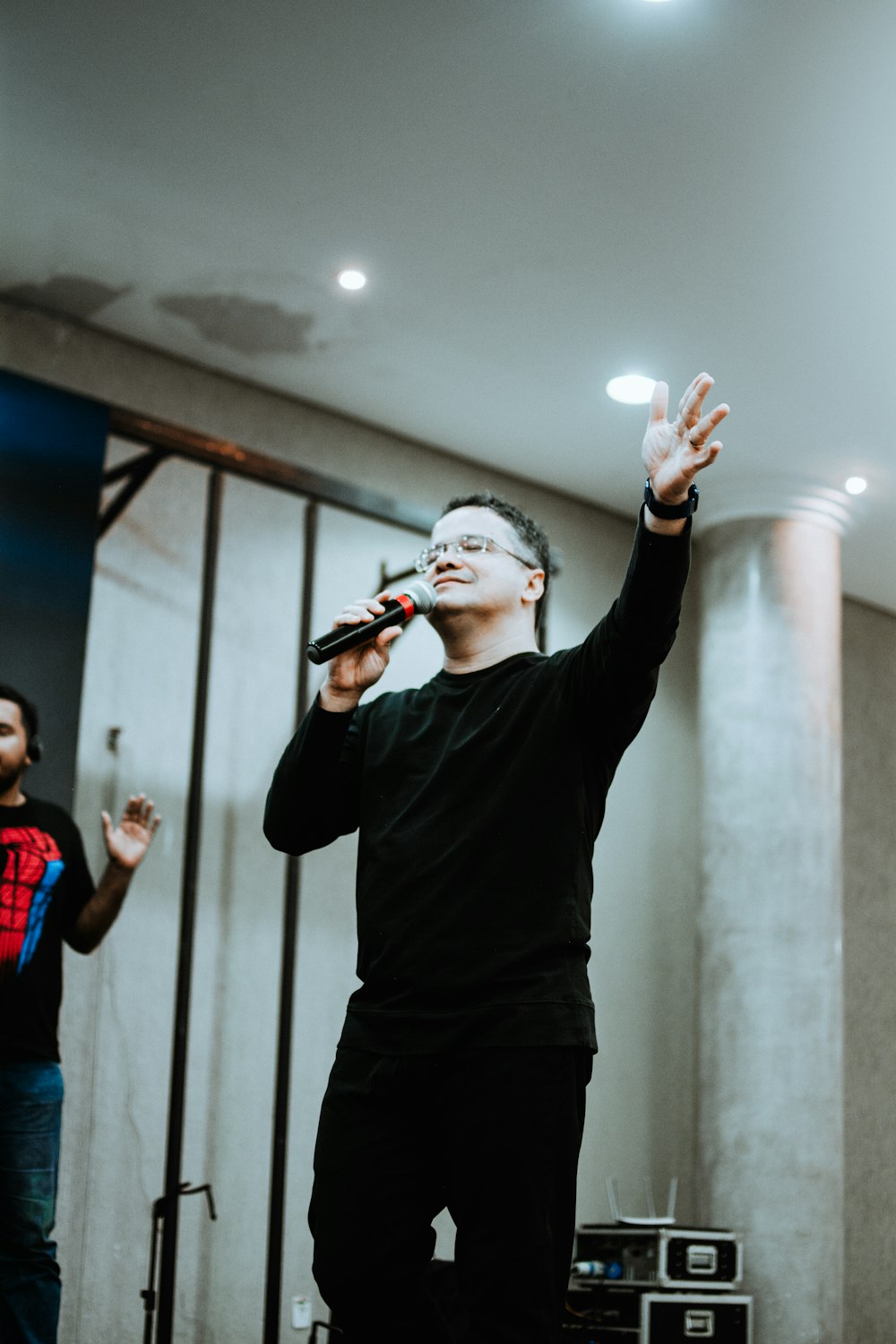 a man standing on a stage holding a microphone