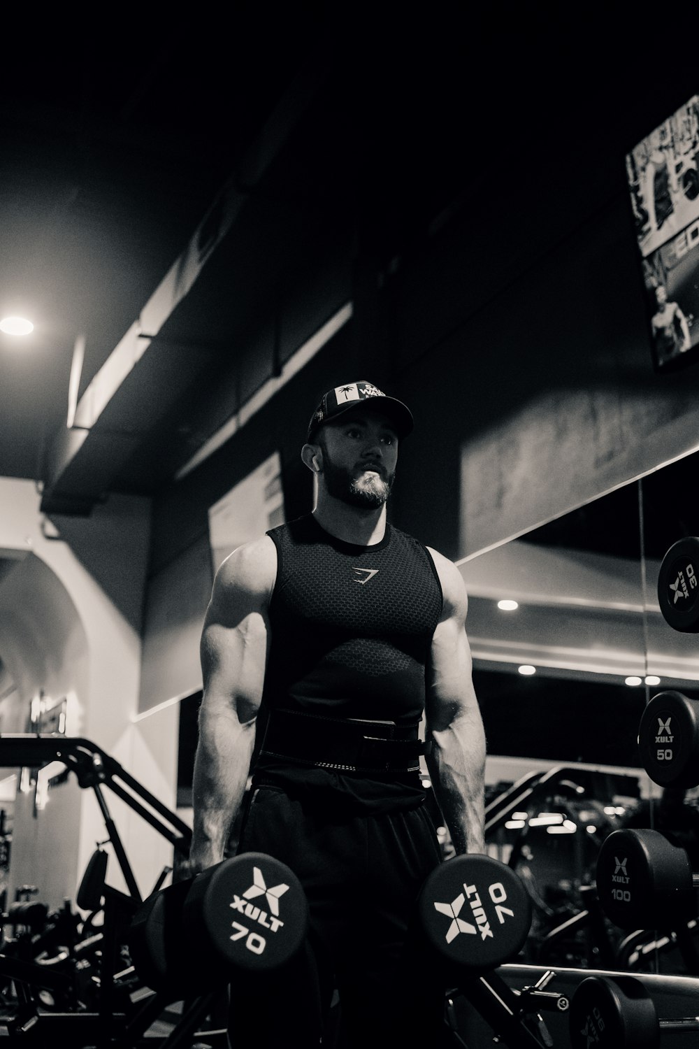 a man in a gym holding a barbell