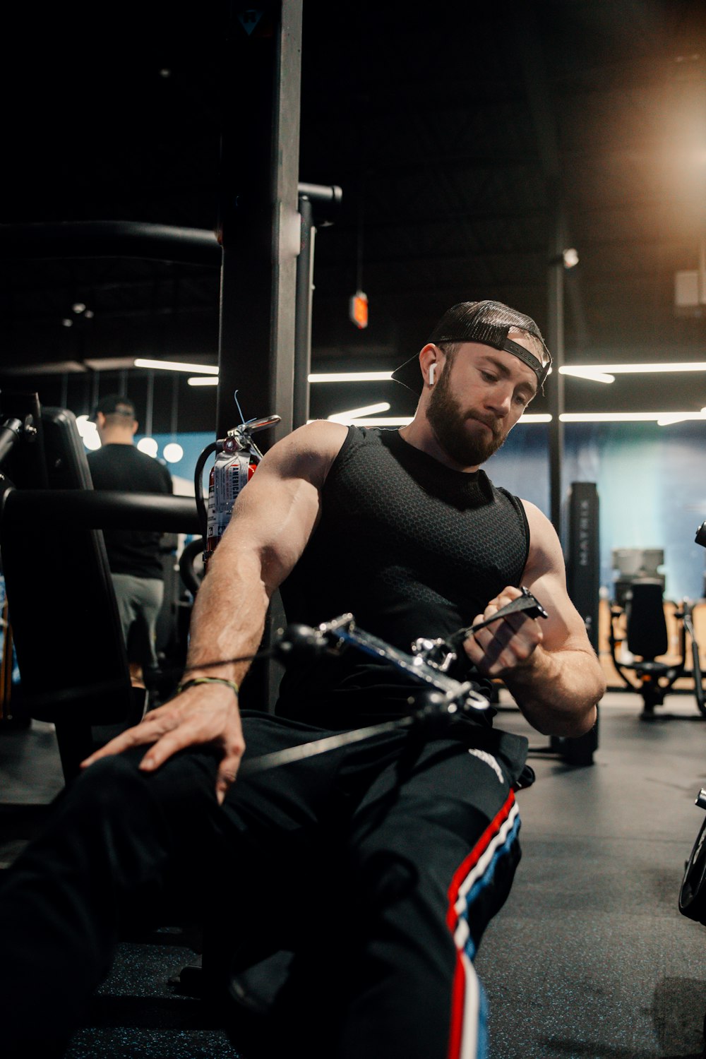 a man sitting on a bench in a gym