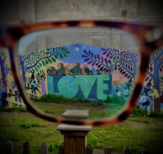 a pair of glasses sitting on top of a wooden table