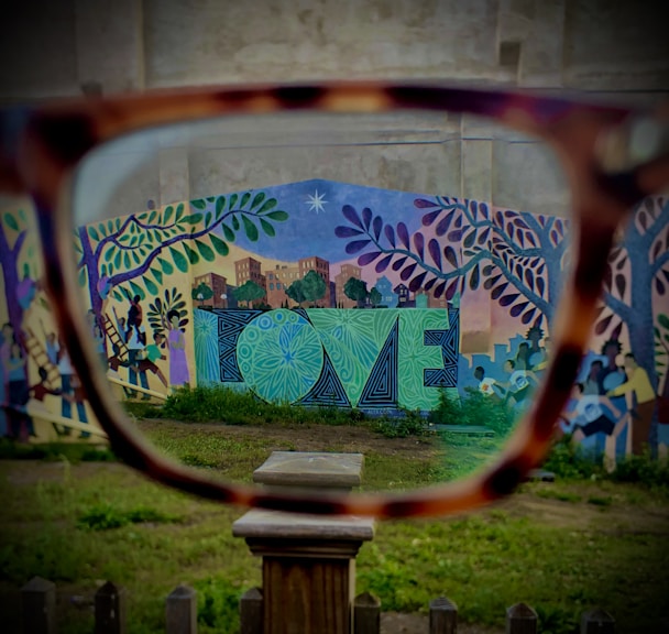 a pair of glasses sitting on top of a wooden table