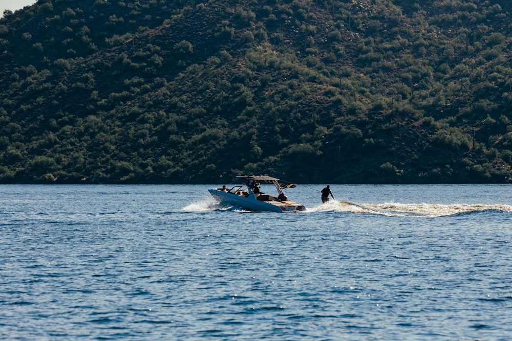 a boat with two people on it in the water