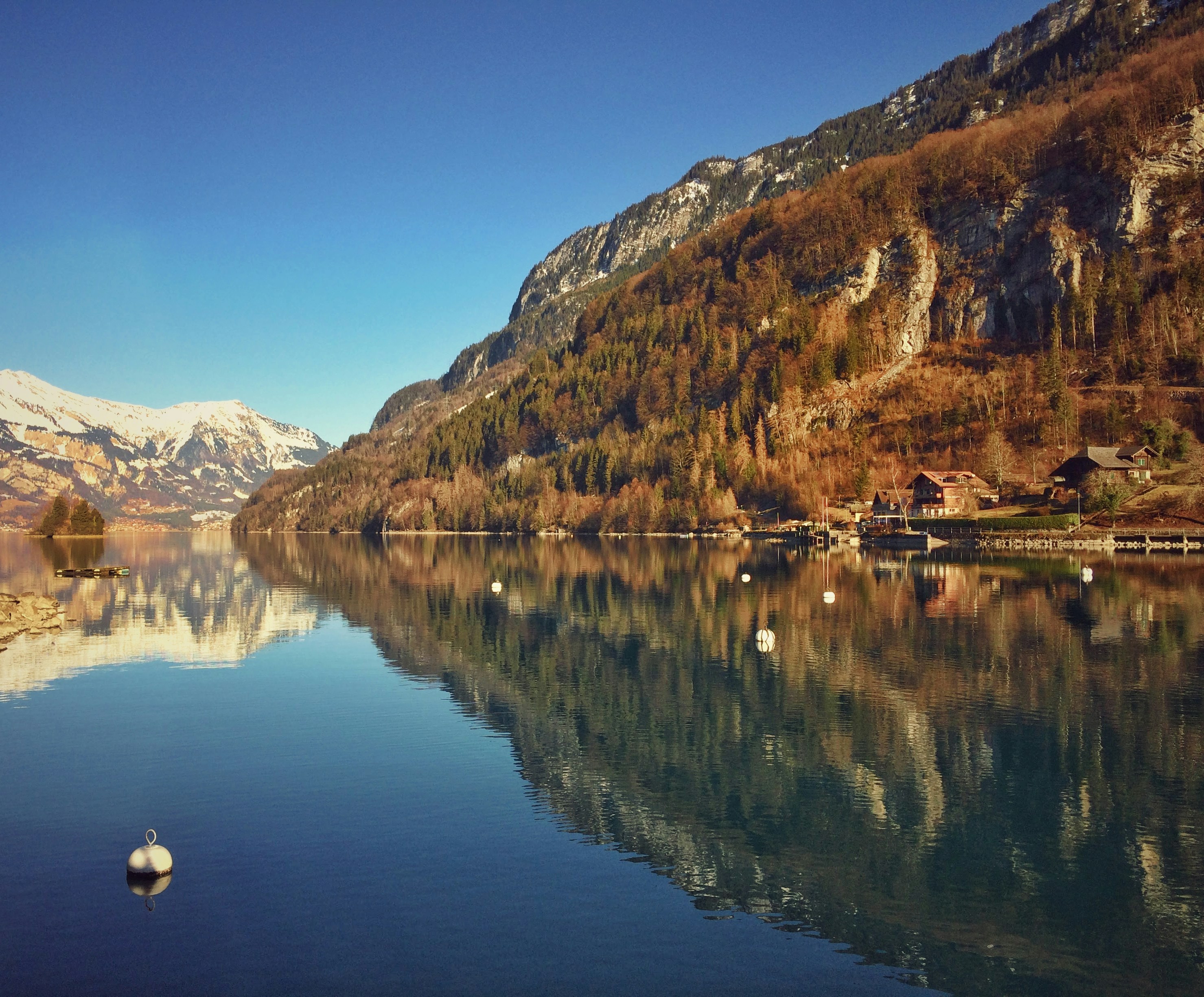 a body of water with mountains in the background