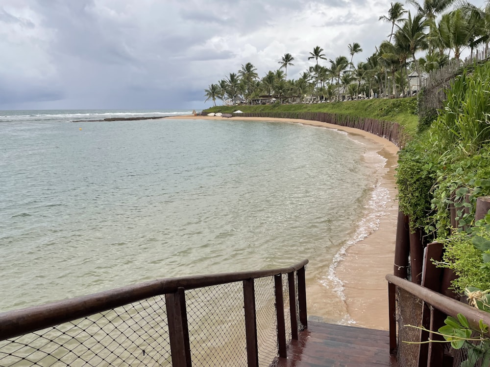 a view of a beach from the top of a set of stairs