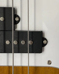 Close-up of reclaimed wood pieces ready for guitar repair.