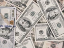 a pile of twenty dollar bills laying on top of each other