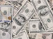 a pile of twenty dollar bills laying on top of each other