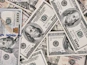 a pile of twenty dollar bills laying on top of each other