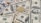 A collection of U.S. hundred dollar bills is scattered with a gold-colored Bitcoin coin placed on top, showcasing a contrast between traditional currency and cryptocurrency.