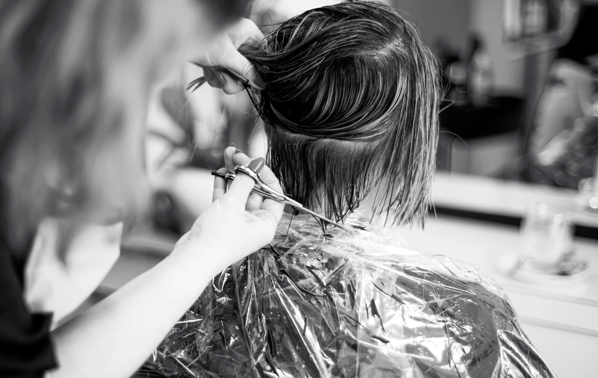 A stylist cutting a client's hair with precision.